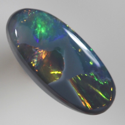SOLID BLACK OPAL Neon bright rolling flashes, orange and green with a touch of blue